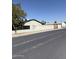 Street view of a block wall surrounding a property with mature trees at 6429 W Palm Ln, Phoenix, AZ 85035