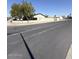 Street view of a block wall surrounding a property with mature trees at 6429 W Palm Ln, Phoenix, AZ 85035
