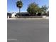 Charming single-story home with desert landscaping, block wall, and mature trees, providing shade at 6429 W Palm Ln, Phoenix, AZ 85035