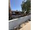 Charming single-story home with desert landscaping, block wall, and mature trees, providing shade at 6429 W Palm Ln, Phoenix, AZ 85035