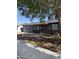 Charming single-story home with desert landscaping, block wall, and mature trees, providing shade at 6429 W Palm Ln, Phoenix, AZ 85035