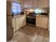 Functional kitchen with white cabinets, stainless steel appliances, and a gas range oven at 6733 W Sherri Jean Ln, Peoria, AZ 85382
