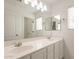 Bright bathroom featuring a double sink vanity, large mirror, and updated fixtures at 694 W Desert Seasons Dr, San Tan Valley, AZ 85143