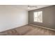 A bedroom with carpeted floors, a ceiling fan, and natural light from a window at 694 W Desert Seasons Dr, San Tan Valley, AZ 85143