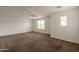 Spacious bedroom with neutral carpet, a ceiling fan, and a bright window for natural light at 694 W Desert Seasons Dr, San Tan Valley, AZ 85143