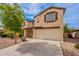 Charming two-story home with a beige stucco exterior and a two-car garage at 694 W Desert Seasons Dr, San Tan Valley, AZ 85143