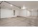 Large garage with ample space, a water heater, and an overhead door at 694 W Desert Seasons Dr, San Tan Valley, AZ 85143