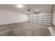 Spacious, well-lit garage with a concrete floor and a white garage door at 694 W Desert Seasons Dr, San Tan Valley, AZ 85143