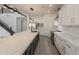 Modern kitchen with white cabinetry, stainless steel appliances, a large island, and stylish pendant lighting at 694 W Desert Seasons Dr, San Tan Valley, AZ 85143