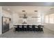 Modern kitchen with white cabinetry, a large island, stainless steel appliances, and stylish barstool seating at 694 W Desert Seasons Dr, San Tan Valley, AZ 85143