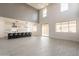 Bright, open-concept living room showcasing large windows and a modern kitchen with a breakfast bar at 694 W Desert Seasons Dr, San Tan Valley, AZ 85143