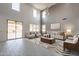 Open living room with a sliding glass door, modern furniture, clerestory windows, and a neutral color palette at 694 W Desert Seasons Dr, San Tan Valley, AZ 85143
