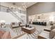 Bright living room with high ceilings, modern chandelier, neutral furniture, and an open floor plan at 694 W Desert Seasons Dr, San Tan Valley, AZ 85143