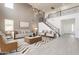 Bright living room featuring a stairway, modern chandelier, neutral furniture, and a decorative rug at 694 W Desert Seasons Dr, San Tan Valley, AZ 85143