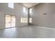 A spacious living area offers a sliding glass door leading to the backyard, tile flooring, and tall ceilings for plenty of natural light at 694 W Desert Seasons Dr, San Tan Valley, AZ 85143
