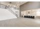A living space boasts tall ceilings, an open floorplan, a staircase with iron railing, and modern light fixtures above at 694 W Desert Seasons Dr, San Tan Valley, AZ 85143