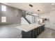 A large living space features tile flooring, gray accent wall, and an open floorplan with modern light fixtures throughout at 694 W Desert Seasons Dr, San Tan Valley, AZ 85143
