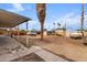 View of spacious dirt backyard with scattered trees, featuring a truck at 7502 W Cora Ln, Phoenix, AZ 85033