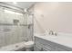Bathroom featuring tiled shower and a gray vanity with modern fixtures at 7502 W Cora Ln, Phoenix, AZ 85033