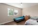 Bedroom featuring tile floor, two beds and a large window at 7502 W Cora Ln, Phoenix, AZ 85033