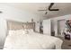Large bedroom features a ceiling fan, doorway to the bathroom and adjacent doorway to the kitchen at 7502 W Cora Ln, Phoenix, AZ 85033