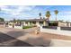 Attractive single-story home with a manicured front yard, privacy features, and convenient covered parking area at 7502 W Cora Ln, Phoenix, AZ 85033