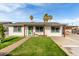 Charming single-story home with a lush green lawn and inviting curb appeal, a perfect Gathering starter home at 7502 W Cora Ln, Phoenix, AZ 85033