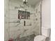 Updated walk-in shower with glass doors, modern tile and a toile at 7502 W Cora Ln, Phoenix, AZ 85033