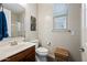 Bright bathroom featuring a dark wood vanity, neutral walls, and a shower behind a glass enclosure at 7939 W Fetlock Trl, Peoria, AZ 85383