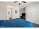 Bedroom with large closet, television, and ensuite bathroom with a window for plenty of natural light at 7939 W Fetlock Trl, Peoria, AZ 85383