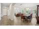 Elegant dining room with a large table, chair set, tile floors, and natural light perfect for Gathering dining at 7939 W Fetlock Trl, Peoria, AZ 85383