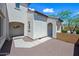 Exterior side view of the house with stucco walls, red tile roof and landscaped backyard at 7939 W Fetlock Trl, Peoria, AZ 85383