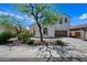 Charming two-story home featuring a well-maintained yard with mature trees and an attached two-car garage at 7939 W Fetlock Trl, Peoria, AZ 85383