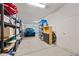 Spacious garage with ample storage and a modern blue car parked inside, lit by overhead lighting at 7939 W Fetlock Trl, Peoria, AZ 85383
