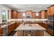 Well-equipped kitchen with custom cabinets, granite counters, a central island, and modern appliances, perfect for cooking at 7939 W Fetlock Trl, Peoria, AZ 85383