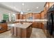 Spacious kitchen with granite countertops, stainless steel appliances, tile floors, and ample cabinet space at 7939 W Fetlock Trl, Peoria, AZ 85383