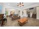Bright and airy living room featuring comfortable seating, a fireplace, and an open layout, ideal for entertaining at 7939 W Fetlock Trl, Peoria, AZ 85383