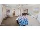 A main bedroom features neutral paint, carpet, ceiling fan, and an ensuite bathroom at 7939 W Fetlock Trl, Peoria, AZ 85383