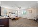 A main bedroom features neutral paint, carpet, ceiling fan, and large windows at 7939 W Fetlock Trl, Peoria, AZ 85383