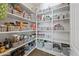 A well-organized pantry with white shelving and gray baskets for storage at 7939 W Fetlock Trl, Peoria, AZ 85383