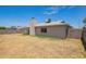 Exterior view of the home with a spacious backyard and block fence at 8807 W Cinnabar Ave, Peoria, AZ 85345