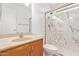 Bathroom featuring wood cabinets, light countertops and a shower with glass doors at 8807 W Cinnabar Ave, Peoria, AZ 85345