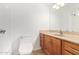 Bathroom featuring a tub, toilet, and vanity with wood cabinets and light countertops at 8807 W Cinnabar Ave, Peoria, AZ 85345