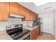 Stainless steel appliances and granite countertops compliment the wood cabinets in this updated kitchen at 8807 W Cinnabar Ave, Peoria, AZ 85345