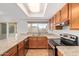 Well-lit kitchen featuring granite countertops, stainless steel appliances, and tile flooring at 8807 W Cinnabar Ave, Peoria, AZ 85345