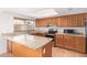 An updated kitchen with granite countertops, wood cabinets and stainless steel appliances provides ample counter space at 8807 W Cinnabar Ave, Peoria, AZ 85345