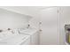 Bright laundry room featuring a washer, dryer, and white shelving for storage at 8807 W Cinnabar Ave, Peoria, AZ 85345