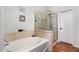 Bathroom featuring a soaking tub and a frameless glass shower, complemented by stylish fixtures at 9545 E Gary St, Mesa, AZ 85207
