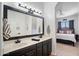 Bathroom featuring double sinks with granite counters, black fixtures, and a view to the main bedroom at 9545 E Gary St, Mesa, AZ 85207