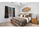 Comfortable bedroom featuring a large window, ceiling fan and decorative art work above the bed at 9545 E Gary St, Mesa, AZ 85207